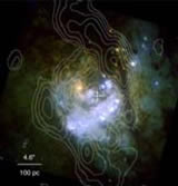 The center of a nearby barred galaxy M83. The SMA data in contours show the distribution of cold gas along dust lanes and a starburst ring (Sakamoto et al. 2004, ApJ, 616, L59), while the color image in the background is taken by the HST in the visible li