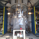 The cryostat chamber mounted on an alumina holding structure (The dewar frame) shown in the center of the picture. Except for few instruments fixed on the dewar frame, most frontend hardware is installed into 36U height rack that locates on dewar left and right side. The vacuum pump sits under the dewar with long bellow pipe connect to the dewar chamber.